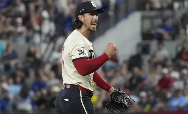 Texas Rangers starting pitcher Michael Lorenzen reacts after a third strike and third out against Tampa Bay Rays designated hitter Brandon Lowe, ending a bases-loaded situation during the fifth inning of a baseball game in Arlington, Texas, Friday, July 5, 2024. (AP Photo/LM Otero)