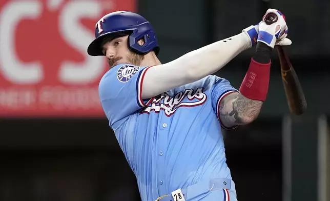 Texas Rangers' Jonah Heim lines out to Tampa Bay Rays third baseman Isaac Paredes in the eighth inning of a baseball game in Arlington, Texas, Sunday, July 7, 2024. (AP Photo/Tony Gutierrez)