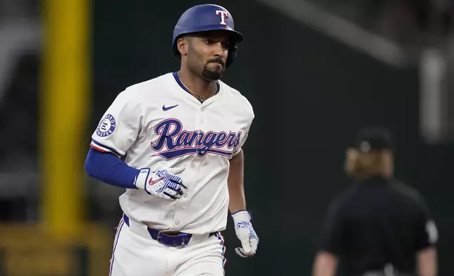 Texas Rangers' Marcus Semien rounds the bases after hitting a two-run home run against the Tampa Bay Rays in the seventh inning of a baseball game in Arlington, Texas, Saturday, July 6, 2024. (AP Photo/Tony Gutierrez)