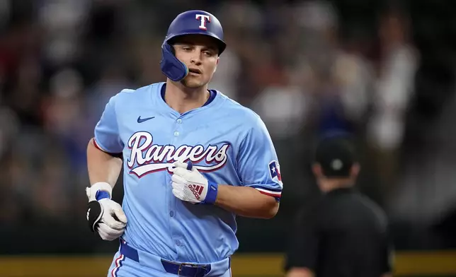 Texas Rangers' Corey Seager rounds the bases after hitting a three-run home run against the Tampa Bay Rays in the fourth inning of a baseball game in Arlington, Texas, Sunday, July 7, 2024. (AP Photo/Tony Gutierrez)