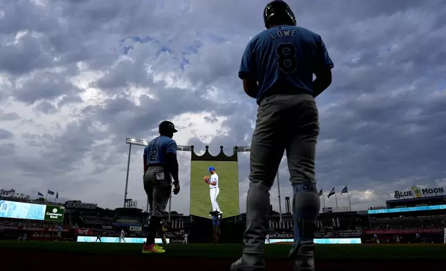 Tampa Bay Rays' Yandy Diaz (2) and Brandon Lowe (8) wait to back before a baseball game against the Kansas City Royals Tuesday, July 2, 2024, in Kansas City, Mo. (AP Photo/Charlie Riedel)