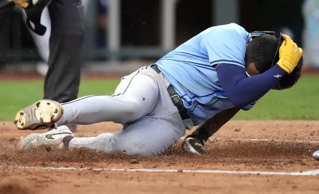 Tampa Bay Rays' Richie Palacios slides home to score on a wild pitch thrown by Kansas City Royals starting pitcher Brady Singer during the second inning of a baseball game Tuesday, July 2, 2024, in Kansas City, Mo. (AP Photo/Charlie Riedel)