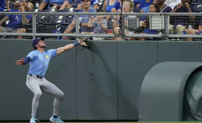 Tampa Bay Rays right fielder Josh Lowe catches a fly foul ball for the out on Kansas City Royals' Bobby Witt Jr. during the first inning of a baseball game Tuesday, July 2, 2024, in Kansas City, Mo. (AP Photo/Charlie Riedel)