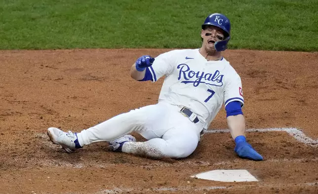 Kansas City Royals' Bobby Witt Jr. slides home to score on a single by Vinnie Pasquantino during the third inning of a baseball game against the Tampa Bay Rays Wednesday, July 3, 2024, in Kansas City, Mo. (AP Photo/Charlie Riedel)