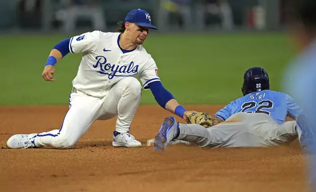 Tampa Bay Rays' Jose Siri (22) beats the tag by Kansas City Royals shortstop Bobby Witt Jr. to steal second during the fourth inning of a baseball game Tuesday, July 2, 2024, in Kansas City, Mo. (AP Photo/Charlie Riedel)