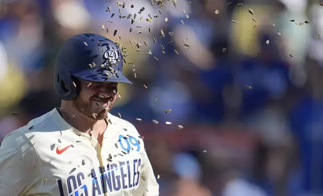 Los Angeles Dodgers' Gavin Lux has sunflower seeds thrown at him after his solo home run during the second inning of a baseball game against the Boston Red Sox, Saturday, July 20, 2024, in Los Angeles. (AP Photo/Marcio Jose Sanchez)