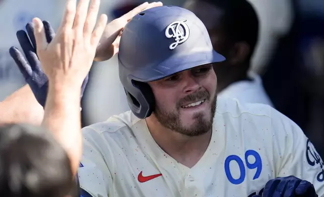 Los Angeles Dodgers' Gavin Lux celebrates in the dugout after his solo home run during the second inning of a baseball game against the Boston Red Sox, Saturday, July 20, 2024, in Los Angeles. (AP Photo/Marcio Jose Sanchez)