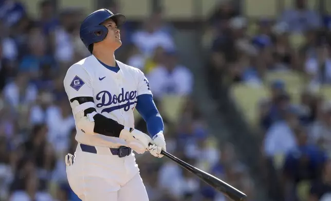 Los Angeles Dodgers designated hitter Shohei Ohtani watches his solo home run during the fifth inning of a baseball game against the Boston Red Sox, Sunday, July 21, 2024, in Los Angeles. (AP Photo/Ryan Sun)