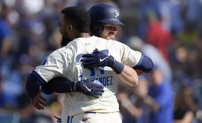 Los Angeles Dodgers' Gavin Lux, right, celebrates after his solo home run with Teoscar Hernández, left, during the second inning of a baseball game against the Boston Red Sox, Saturday, July 20, 2024, in Los Angeles. (AP Photo/Marcio Jose Sanchez)