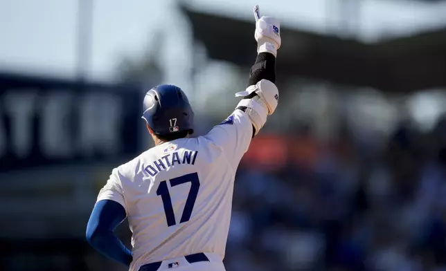 Los Angeles Dodgers designated hitter Shohei Ohtani celebrates while running the bases after hitting a solo home run during the fifth inning of a baseball game against the Boston Red Sox, Sunday, July 21, 2024, in Los Angeles. (AP Photo/Ryan Sun)