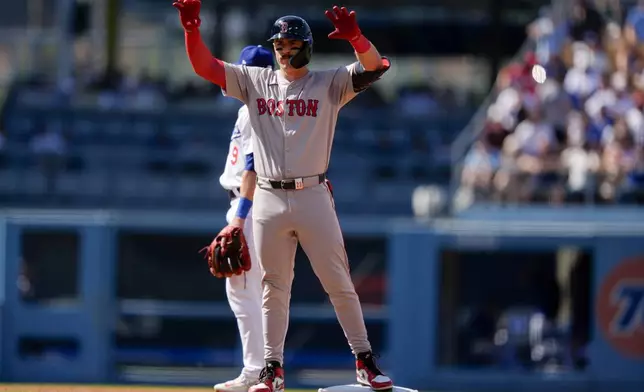 Boston Red Sox' Romy Gonzalez celebrates after hitting a double during the first inning of a baseball game against the Los Angeles Dodgers, Sunday, July 21, 2024, in Los Angeles. (AP Photo/Ryan Sun)