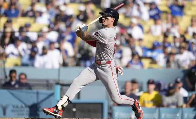 Boston Red Sox's Jarren Duran follows through on a two-run double during the fifth inning of a baseball game against the Los Angeles Dodgers, Saturday, July 20, 2024, in Los Angeles. (AP Photo/Marcio Jose Sanchez)