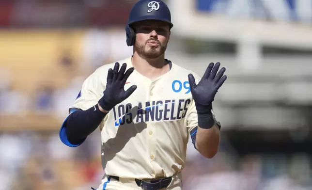 Los Angeles Dodgers' Gavin Lux celebrates as he rounds the bases following his solo home run during the second inning of a baseball game against the Boston Red Sox, Saturday, July 20, 2024, in Los Angeles. (AP Photo/Marcio Jose Sanchez)