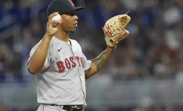 Boston Red Sox starting pitcher Brayan Bello reacts after he was charged with a balk during the first inning of a baseball game against the Miami Marlins, Wednesday, July 3, 2024, in Miami. (AP Photo/Marta Lavandier)