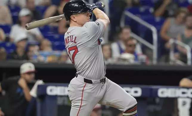 Boston Red Sox's Tyler O'Neill hits a double to center field during the 12th inning of a baseball game against the Miami Marlins, Thursday, July 4, 2024, in Miami. (AP Photo/Marta Lavandier)