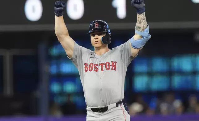 Boston Red Sox's Tyler O'Neill gestures after hitting a double to bring in a run during the 12th inning of a baseball game against the Miami Marlins, Thursday, July 4, 2024, in Miami. (AP Photo/Marta Lavandier)