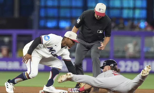 Miami Marlins shortstop Vidal Bruján tags out Boston Red Sox's Wilyer Abreu (52) after trying to steal the base during the fourth inning of a baseball game, Thursday, July 4, 2024, in Miami. (AP Photo/Marta Lavandier)