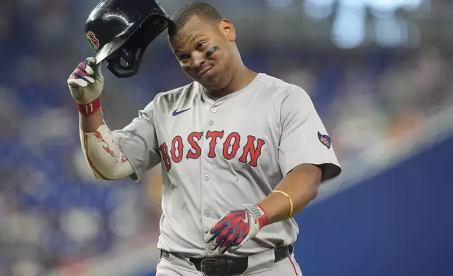 Boston Red Sox third baseman Rafael Devers gestures after he was tagged out at second base during the fourth inning of a baseball game against the Miami Marlins, Thursday, July 4, 2024, in Miami. (AP Photo/Marta Lavandier)