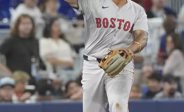 Boston Red Sox third baseman Rafael Devers (11) throws to first base for an out during the fourth inning of a baseball game against the Miami Marlins, Thursday, July 4, 2024, in Miami. (AP Photo/Marta Lavandier)