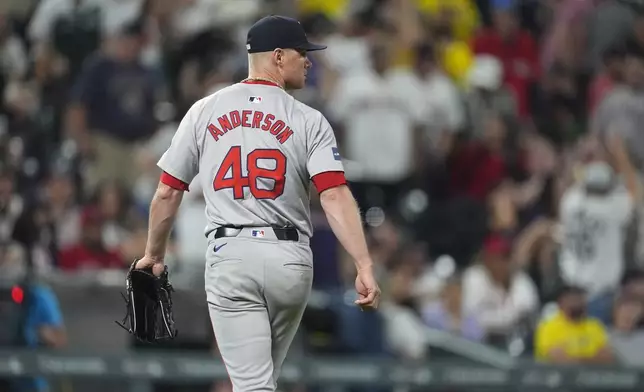 Boston Red Sox relief pitcher Chase Anderson heads to the dugout after giving up a walkoff RBI single to Colorado Rockies' Ezequiel Tovar in the 12th inning of a baseball game Monday, July 22, 2024, in Denver. (AP Photo/David Zalubowski)