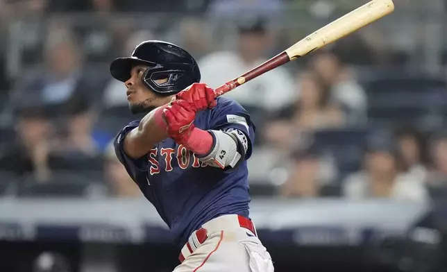 Boston Red Sox's Ceddanne Rafaela follows through on a two-run home run during the 10th inning of a baseball game against the New York Yankees, Friday, July 5, 2024, in New York. (AP Photo/Frank Franklin II)