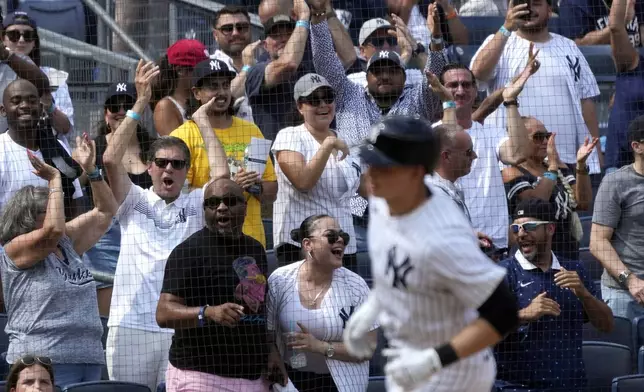 Fans react as New York Yankees' Ben Rice runs home after hitting a home run during the seventh inning of a baseball game against the Boston Red Sox, Saturday, July 6, 2024, in New York. (AP Photo/Pamela Smith)