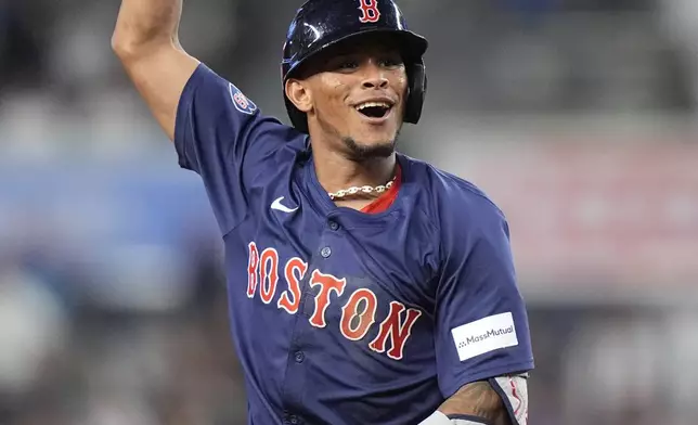 Boston Red Sox's Ceddanne Rafaela gestures toward teammates as he runs the bases after hitting a two-run home run during the 10th inning of a baseball game against the New York Yankees, Friday, July 5, 2024, in New York. (AP Photo/Frank Franklin II)