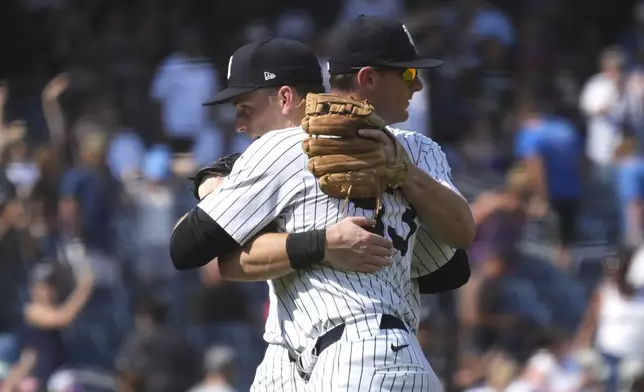 New York Yankees' Ben Rice, front, and DJ LeMahieu celebrate following a baseball game against the Boston Red Sox, Saturday, July 6, 2024, in New York. Rice became the first Yankees rookie to homer three times in a game and drove in seven runs as New York snapped a four-game slide with a 14-4 victory over the Boston Red Sox on Saturday. (AP Photo/Pamela Smith)