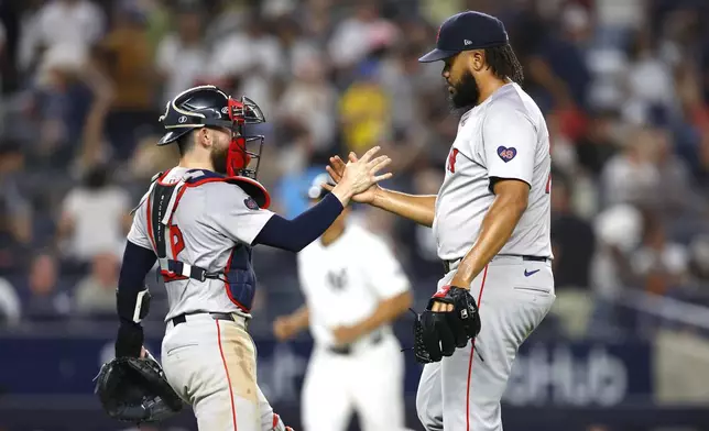 Boston Red Sox's catcher Connor Wong and pitcher Kenley Jansen shake hands after defeating the New York Yankees, Sunday, July 7, 2024 in New York. (AP Photo/Noah K. Murray)