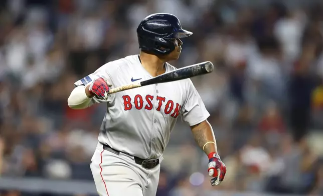 Boston Red Sox's Rafael Devers tosses his bat after hitting a home run against the New York Yankees during seventh inning of a baseball game, Sunday, July 7, 2024, in New York. (AP Photo/Noah K. Murray)