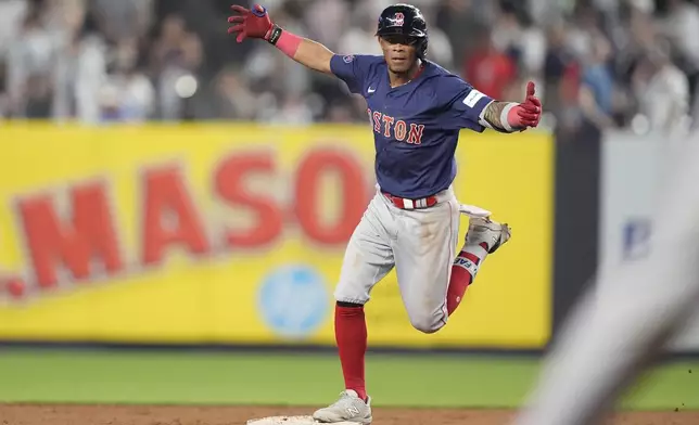 Boston Red Sox's Ceddanne Rafaela gestures toward teammates as he runs the bases after hitting a two-run home run during the 10th inning of a baseball game against the New York Yankees, Friday, July 5, 2024, in New York. (AP Photo/Frank Franklin II)