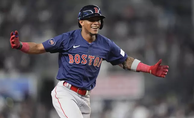 Boston Red Sox's Ceddanne Rafaela (43) gestures toward treammates as he runs the bases after hitting a two-run home run during the tenth inning of a baseball game against the New York Yankees, Friday, July 5, 2024, in New York. The Red Sox won 5-3. (AP Photo/Frank Franklin II)