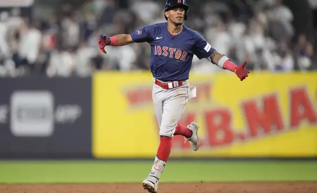 Boston Red Sox's Ceddanne Rafaela gestures toward teammates as he runs the bases after hitting a two-run home run during the 10th inning of a baseball game against the New York Yankees, Friday, July 5, 2024, in New York. (AP Photo/Frank Franklin II)