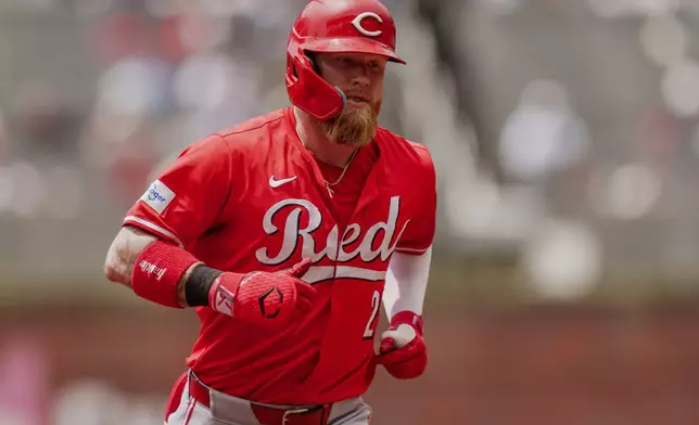 Cincinnati Reds' Jake Fraley rounds second base after hitting a home run in the first inning of the first baseball game of a doubleheader against the Atlanta Braves, Wednesday, July 24, 2024, in Atlanta. (AP Photo/Jason Allen)