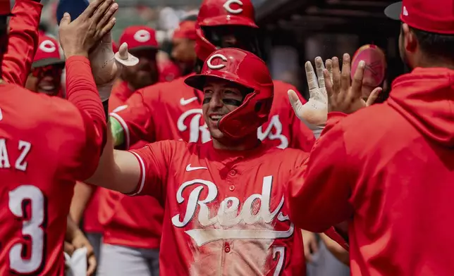 Cincinnati Reds outfielder Spencer Steer (7) celebrates in the dugout after scoring a run in the first inning of the first baseball game of a doubleheader against the Atlanta Braves, Wednesday, July 24, 2024, in Atlanta. (AP Photo/Jason Allen)