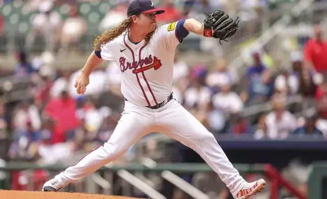 Atlanta Braves pitcher Grant Holmes throws in the third inning of the first baseball game of a doubleheader against the Cincinnati Reds, Wednesday, July 24, 2024, in Atlanta. (AP Photo/Jason Allen)