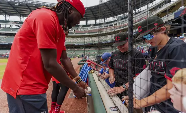 Cincinnati Reds shortstop Elly De La Cruz (44) signs autographs before the first baseball game of a doubleheader against the Atlanta Braves, Wednesday, July 24, 2024, in Atlanta. (AP Photo/Jason Allen)