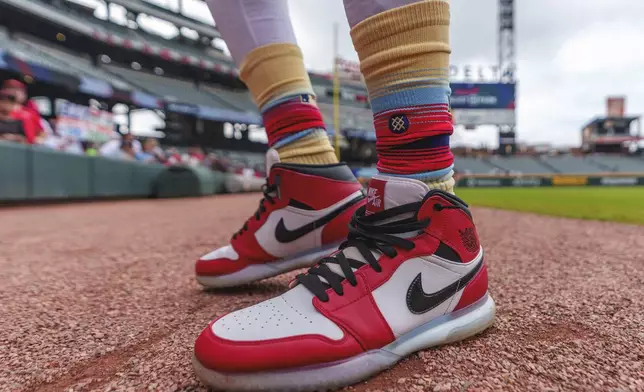 Cincinnati Reds shortstop Elly De La Cruz shows off his Nike Air Jordan turf shoes before the first baseball game of a doubleheader against the Atlanta Braves, Wednesday, July 24, 2024, in Atlanta. (AP Photo/Jason Allen)