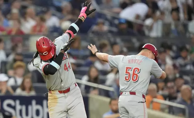 Cincinnati Reds' Elly De La Cruz, left, celebrates with third base coach J.R. House, right, as he runs the bases after hitting a two-run home run during the fifth inning of a baseball gameagainst the New York Yankees, Tuesday, July 2, 2024, in New York. (AP Photo/Frank Franklin II)