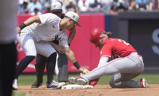 Cincinnati Reds' Jake Fraley, right, steals second base as New York Yankees second baseman Gleyber Torres attempts to tag him out during the fourth inning of a baseball game, Thursday, July 4, 2024, in New York. (AP Photo/Pamela Smith)