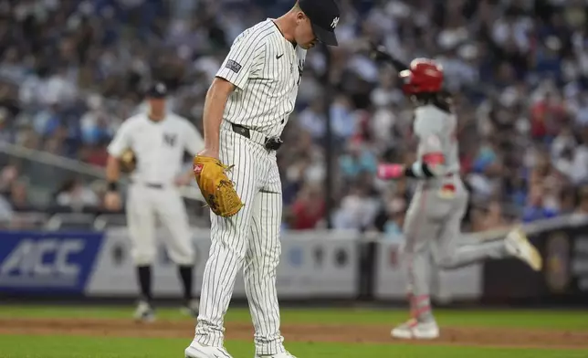 New York Yankees pitcher Caleb Ferguson, center, reacts as Cincinnati Reds' Elly De La Cruz, right, runs the bases after hitting a two-run home run during the fifth inning of a baseball game, Tuesday, July 2, 2024, in New York. (AP Photo/Frank Franklin II)