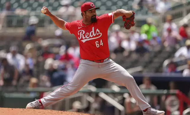 Cincinnati Reds pitcher Tony Santillan throws in the eighth inning of the first baseball game of a doubleheader against the Atlanta Braves, Wednesday, July 24, 2024, in Atlanta. (AP Photo/Jason Allen)