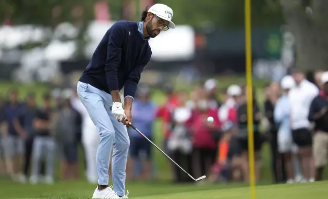 Akshay Bhatia chips onto the third green during the final round of the Rocket Mortgage Classic golf tournament at Detroit Country Club, Sunday, June 30, 2024, in Detroit. (AP Photo/Paul Sancya)