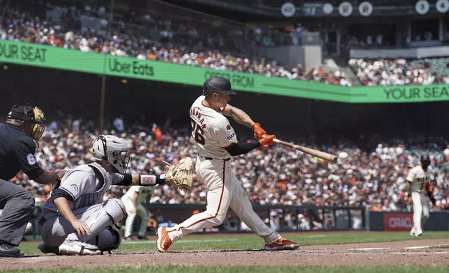 San Francisco Giants' Matt Chapman hits an RBI single against the Colorado Rockies in the sixth inning of a baseball game in San Francisco, Sunday, July 28, 2024. (AP Photo/Kavin Mistry)