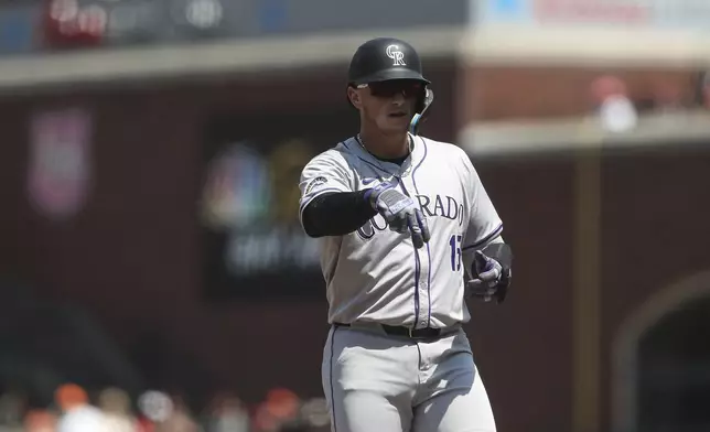 Colorado Rockies' Hunter Goodman celebrates after hitting a single against the San Francisco Giants during the sixth inning of a baseball game in San Francisco, Sunday, July 28, 2024. (AP Photo/Kavin Mistry)