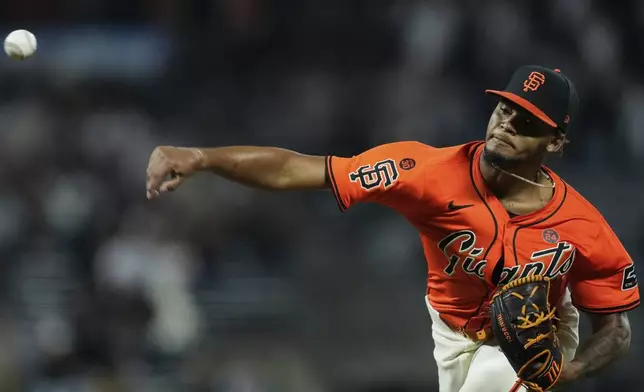 San Francisco Giants pitcher Camilo Doval throws to a Colorado Rockies batter during the ninth inning of a baseball game Friday, July 26, 2024, in San Francisco. (AP Photo/Godofredo A. Vásquez)