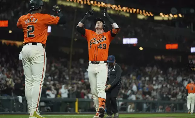 San Francisco Giants' Tyler Fitzgerald (49) celebrates in front of Jorge Soler (2) after hitting a two-run home run against the Colorado Rockies during the sixth inning of a baseball game Friday, July 26, 2024, in San Francisco. (AP Photo/Godofredo A. Vásquez)