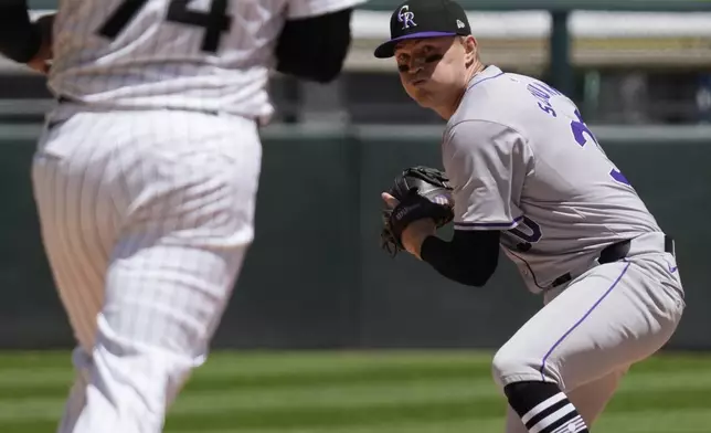 Colorado Rockies second baseman Aaron Schunk, right, throws out Chicago White Sox's Paul DeJong at first after forcing out Eloy Jiménez during the second inning of a baseball game in Chicago, Sunday, June 30, 2024. (AP Photo/Nam Y. Huh)