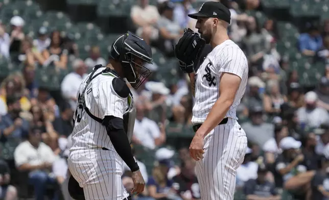 Chicago White Sox starting pitcher Garrett Crochet, right, talks with catcher Martín Maldonado, left, during the second inning of a baseball game against the Chicago White Sox in Chicago, Sunday, June 30, 2024. (AP Photo/Nam Y. Huh)