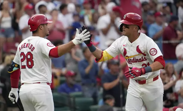 St. Louis Cardinals' Lars Nootbaar (21) is congratulated by teammate Nolan Arenado (28) after hitting a solo home run during the second inning in the second game of a baseball doubleheader against the Kansas City Royals Wednesday, July 10, 2024, in St. Louis. (AP Photo/Jeff Roberson)